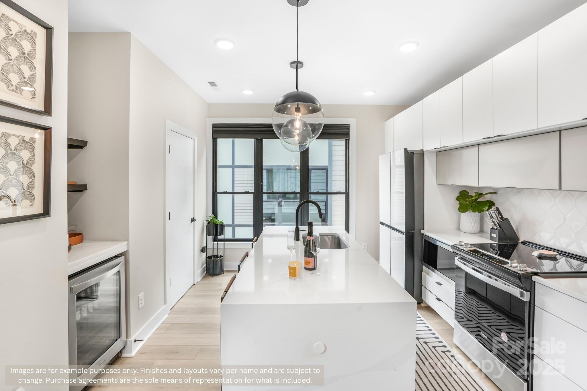 421 Devender Lane, Unit 2 Charlotte, NC 28217 - Photo 13 of 28 a large white kitchen with a large window