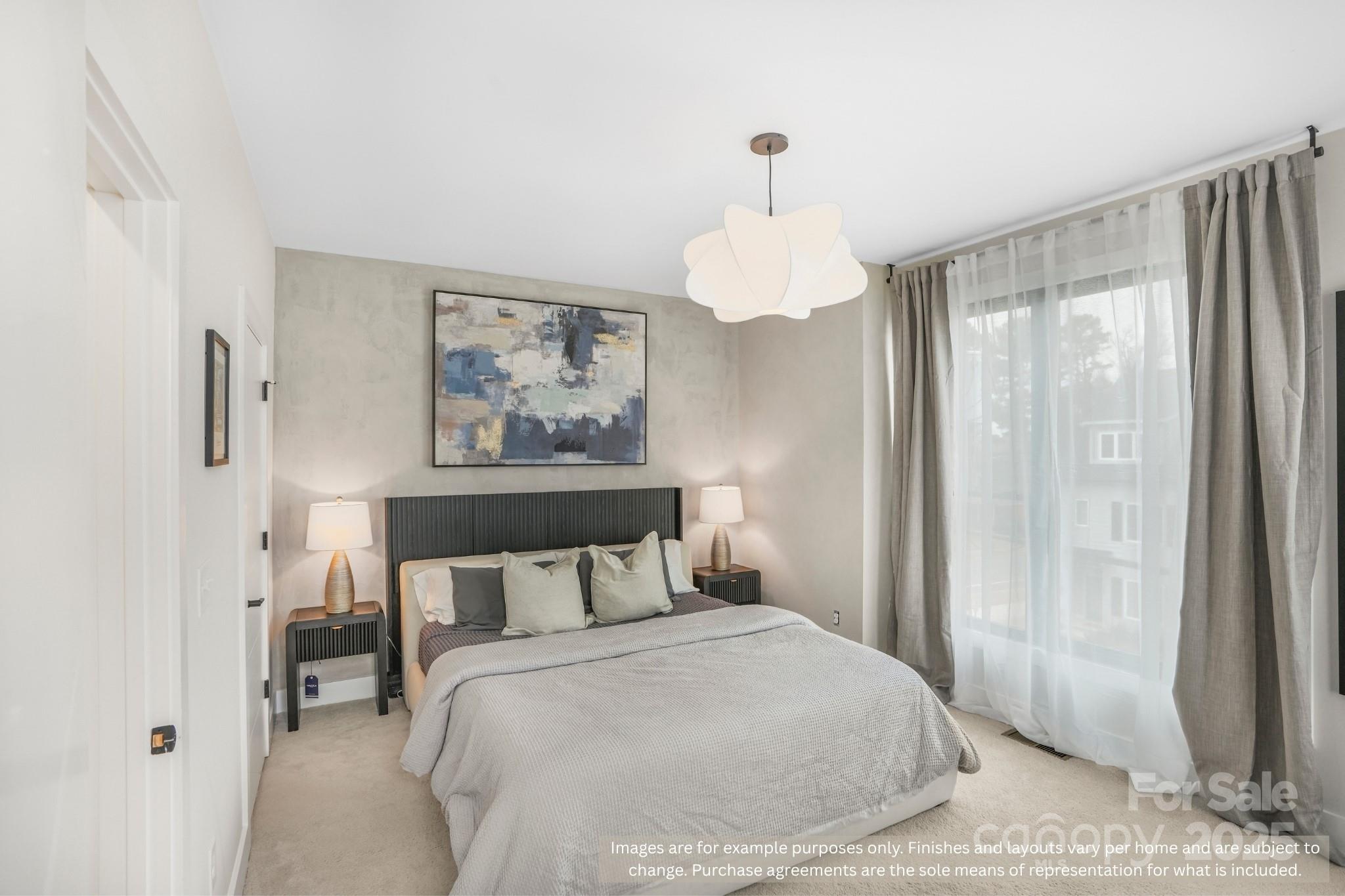 421 Devender Lane, Unit 2 Charlotte, NC 28217 - Photo 15 of 28 a bedroom with a bed and a chandelier