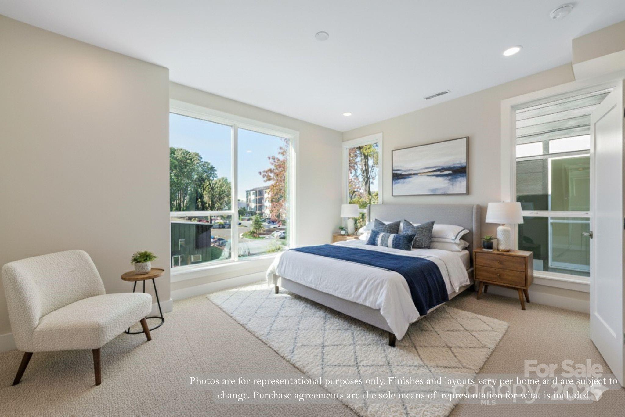 421 Devender Lane, Unit 2 Charlotte, NC 28217 - Photo 6 of 28 a spacious bedroom with a bed and a couch