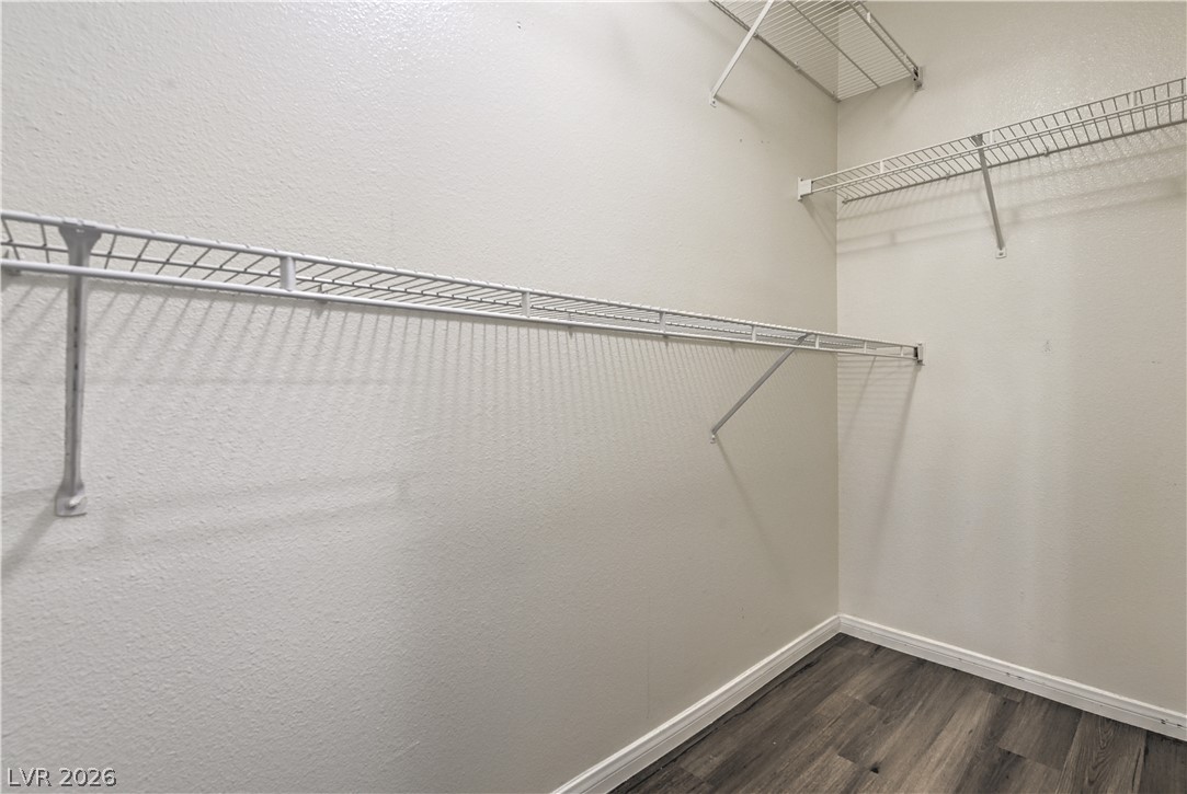 3950 South Sandhill Road, Unit 112 Las Vegas, NV 89121 - Photo 19 of 33 Walk in closet featuring dark wood finished floors