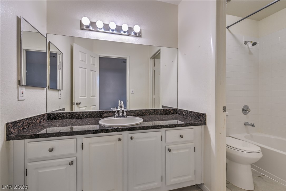 3950 South Sandhill Road, Unit 112 Las Vegas, NV 89121 - Photo 24 of 33 Full bathroom featuring bathtub / shower combination, toilet, and vanity