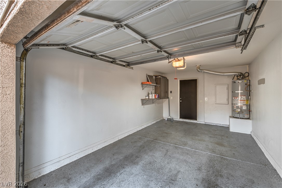 3950 South Sandhill Road, Unit 112 Las Vegas, NV 89121 - Photo 26 of 33 Garage featuring gas water heater, baseboards, and a garage door opener