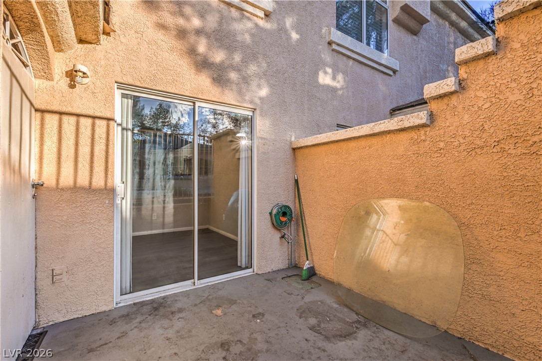3950 South Sandhill Road, Unit 112 Las Vegas, NV 89121 - Photo 27 of 33 Property entrance with stucco siding and a patio