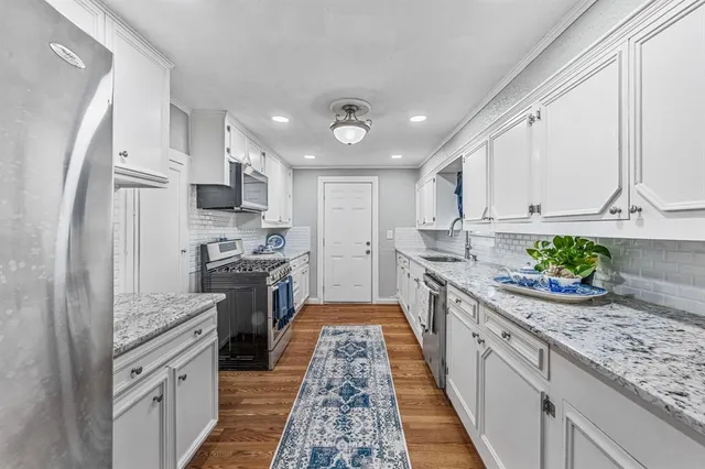 a large kitchen with stainless steel appliances granite countertop lots of counter top space