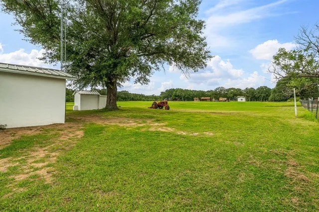 a view of yard with swimming pool and green space