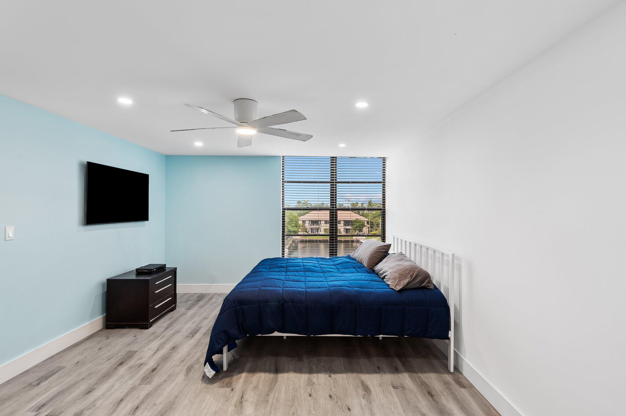 6 Royal Palm Way, Unit 509 Boca Raton, FL 33432 - Photo 11 of 23 a bedroom with a bed and a flat screen tv