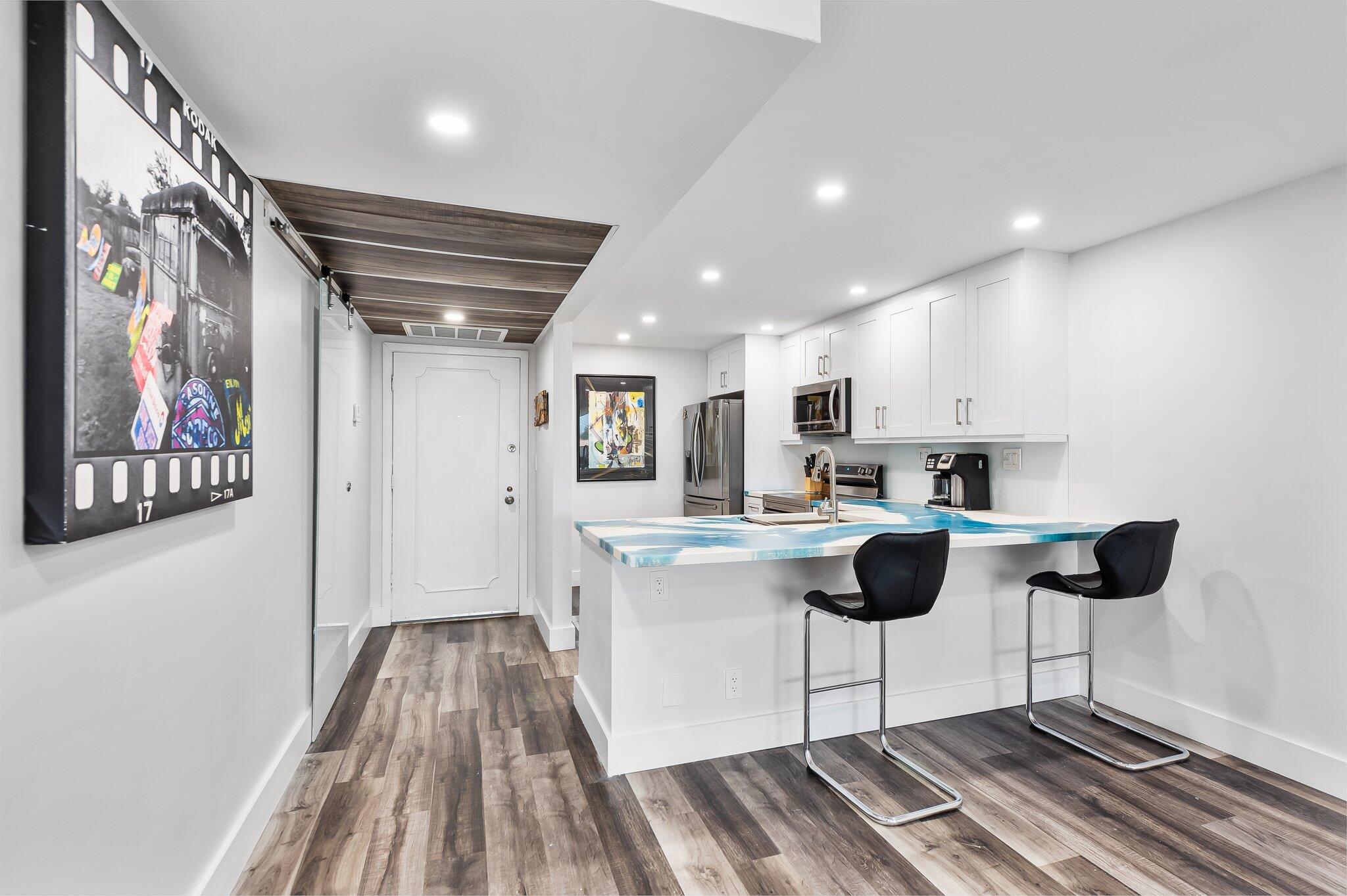 6 Royal Palm Way, Unit 509 Boca Raton, FL 33432 - Photo 5 of 23 a kitchen with a cabinets and chairs