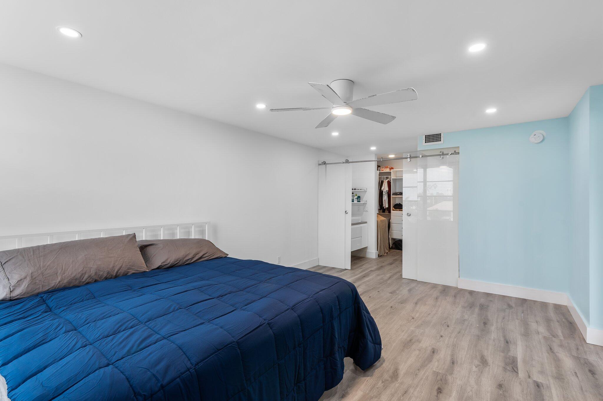 6 Royal Palm Way, Unit 509 Boca Raton, FL 33432 - Photo 9 of 23 a bedroom with a bed and a ceiling fan