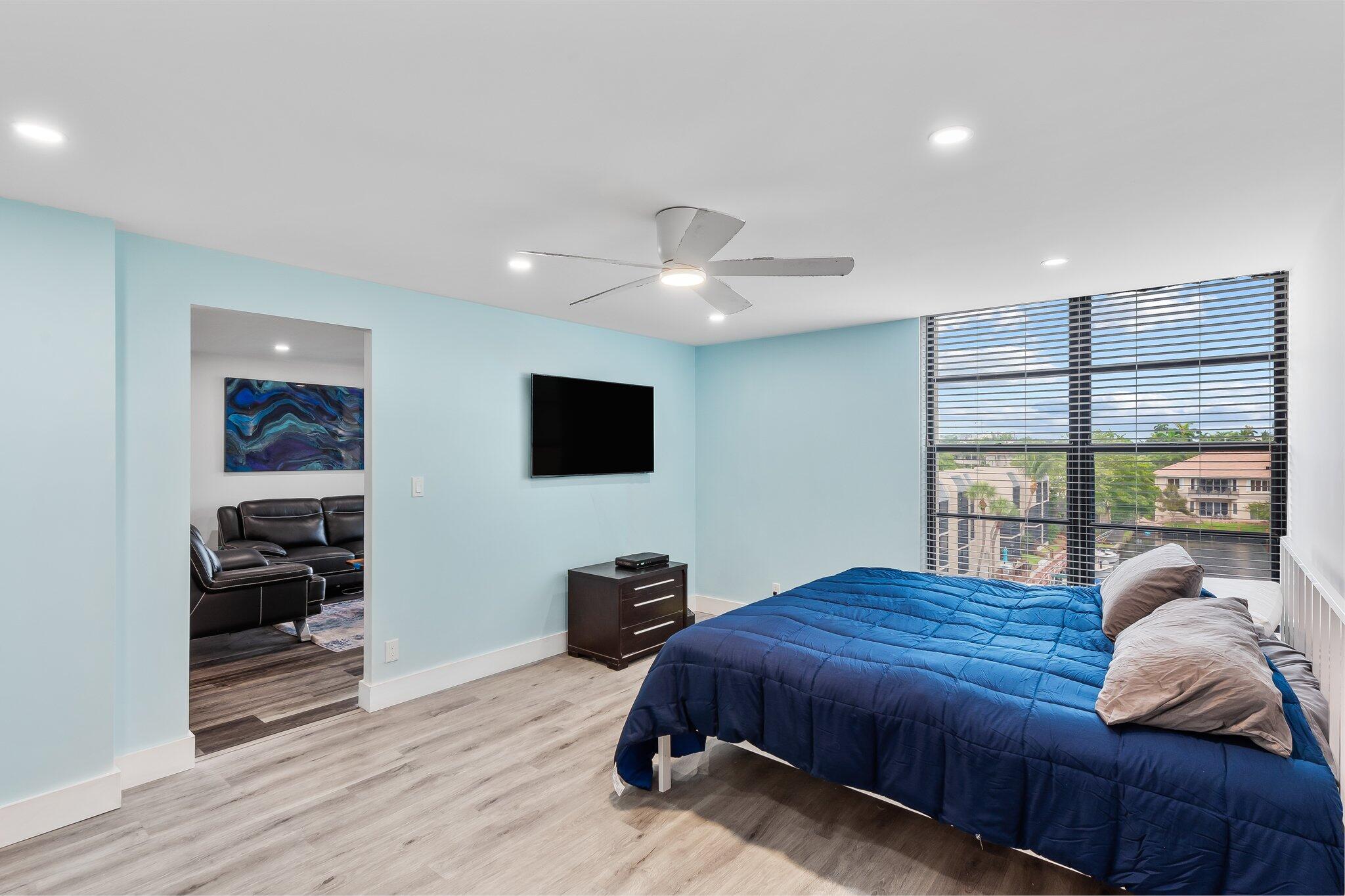 6 Royal Palm Way, Unit 509 Boca Raton, FL 33432 - Photo 10 of 23 a spacious bedroom with a bed and a flat screen tv