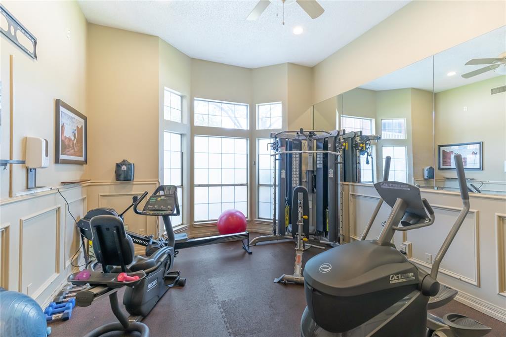 12680 Hillcrest Road, Unit 4101 Dallas, TX 75230 - Photo 35 of 37 Dedicated fitness space featuring bay windows, full-length mirror wall, recessed lighting, and crown molding