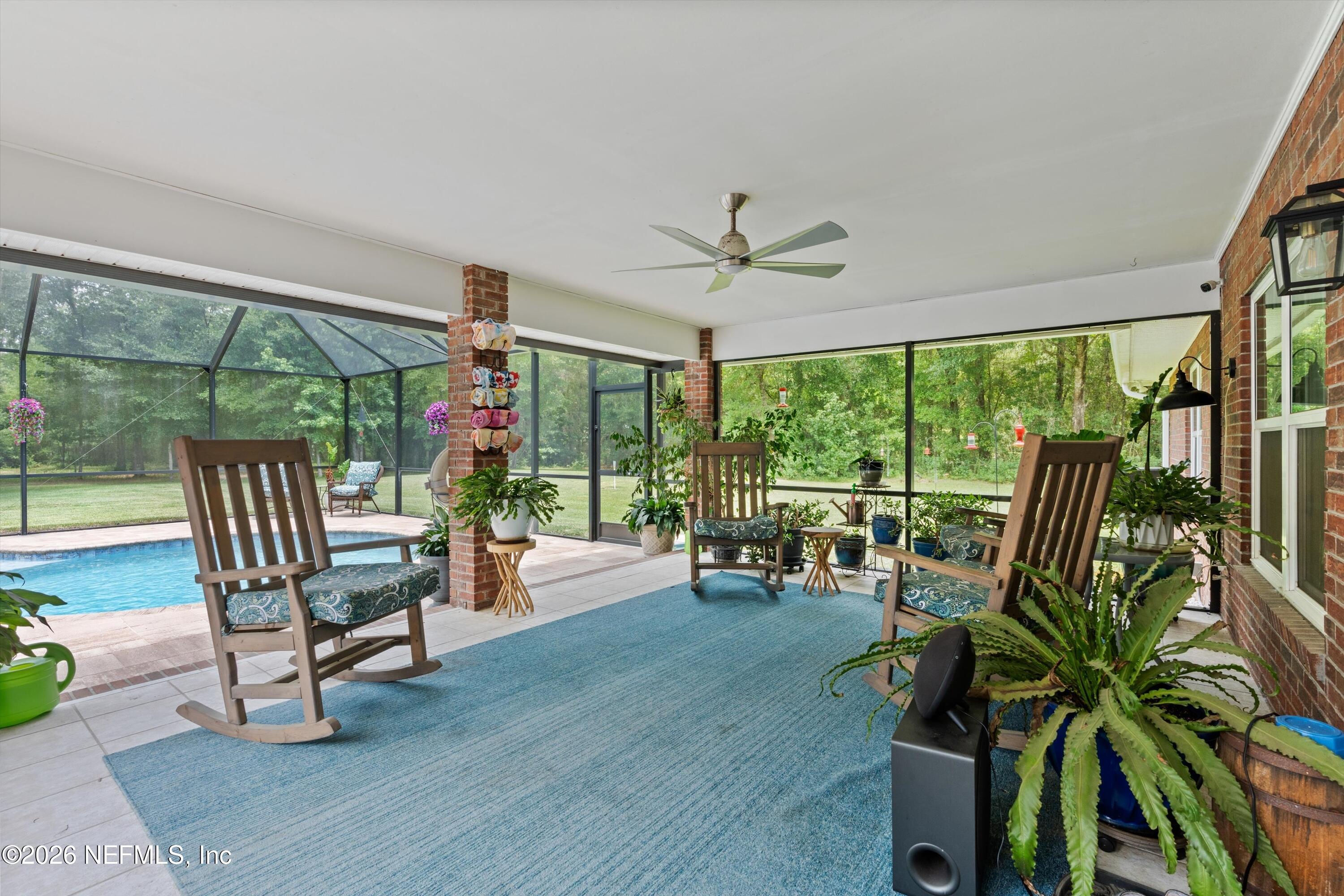 5566 Don Manuel Road Elkton, FL 32033 - Photo 32 of 47 a living room with furniture and a floor to ceiling window