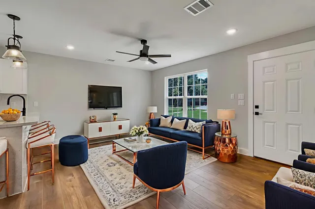 a living room with furniture and a flat screen tv