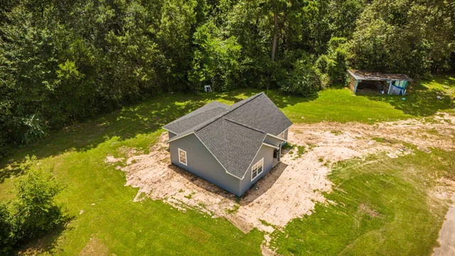 a view of backyard with swimming pool and outdoor seating
