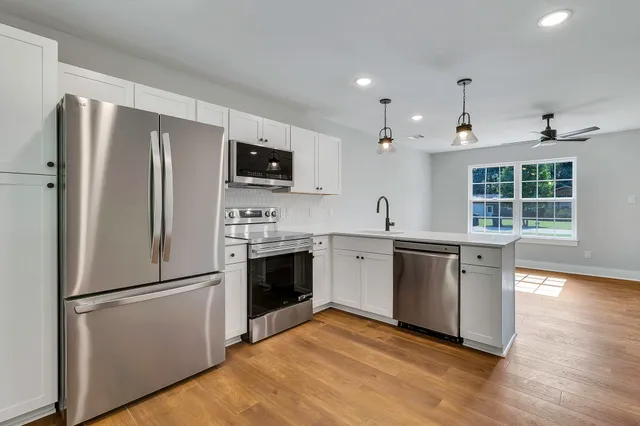a kitchen with a refrigerator stove and sink