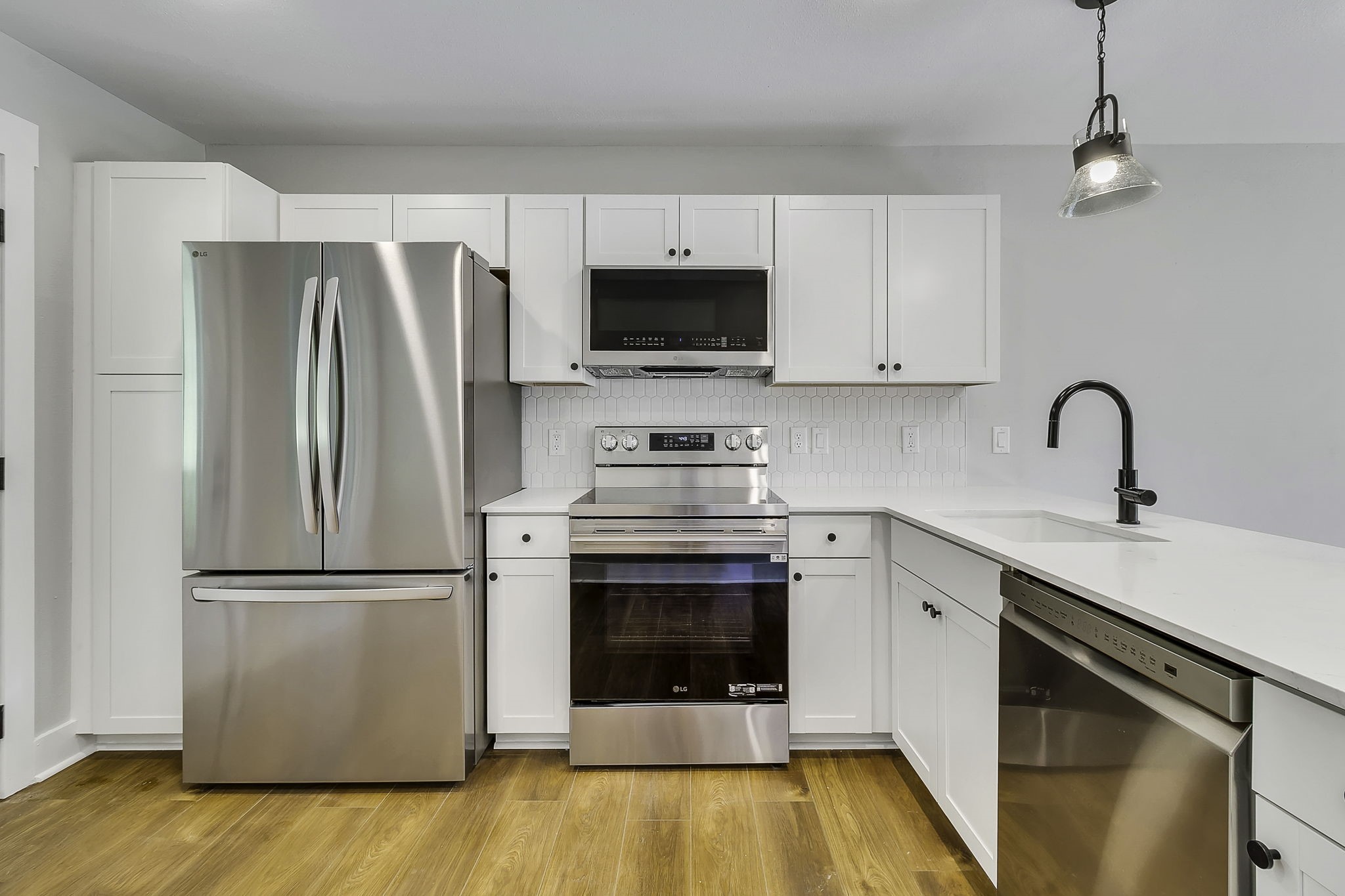 131 Pawnee Onalaska, TX 77360 - Photo 7 of 23 a kitchen with a refrigerator sink and cabinets