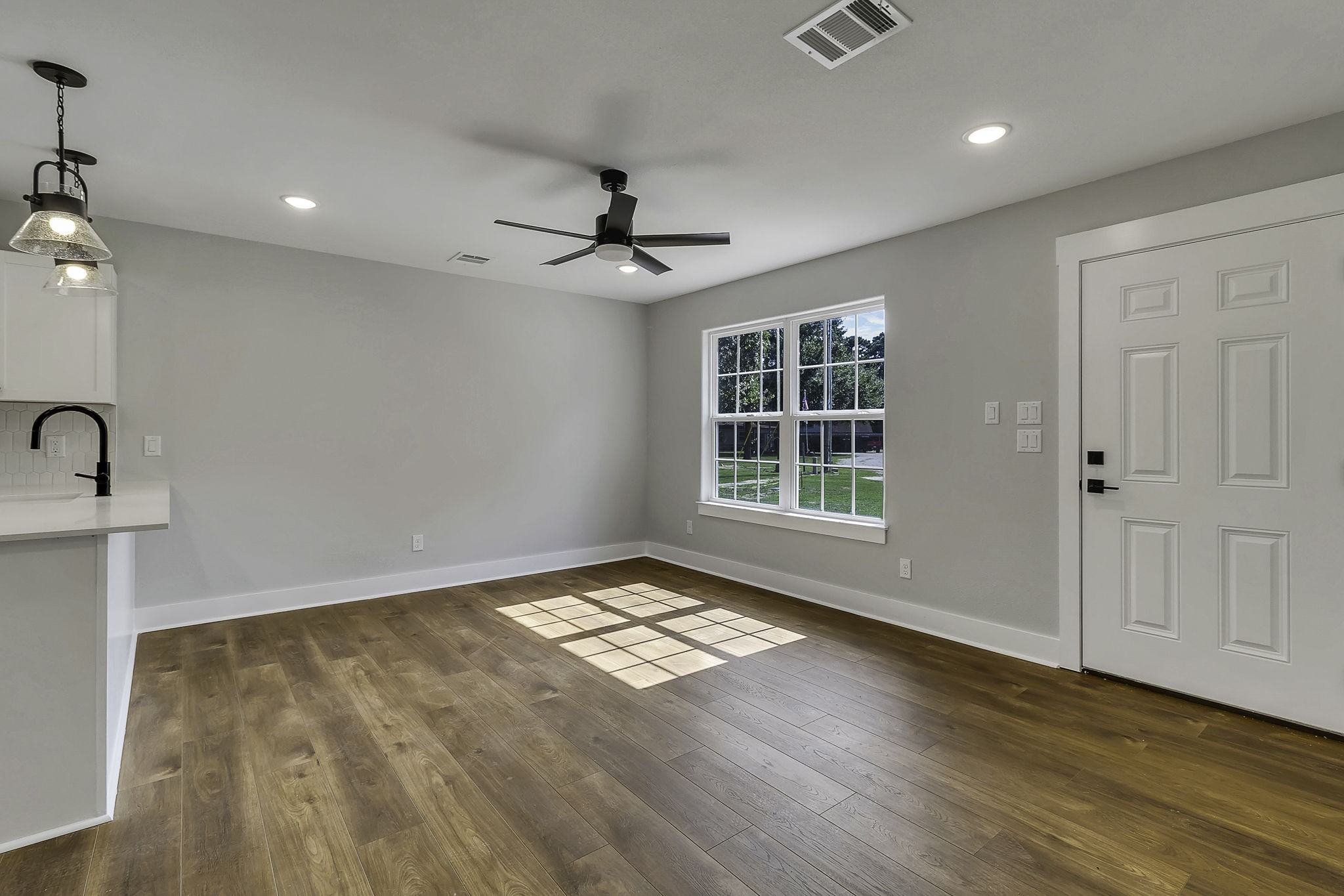 131 Pawnee Onalaska, TX 77360 - Photo 10 of 23 a view of an empty room with a window and wooden floor
