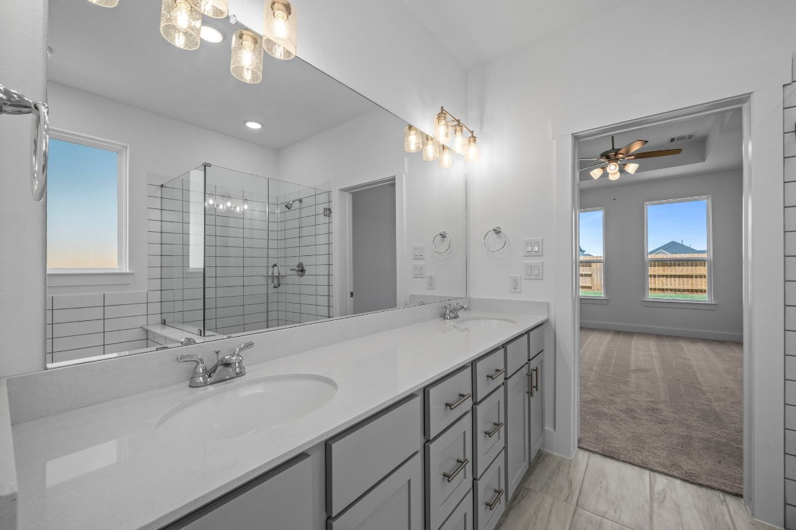 305 Gambels Quail Road Waller, TX 77484 - Photo 11 of 26 The elegant finishes, from the dazzling floors to the chic light fixtures, reflect a careful attention to detail that feels both luxurious and comforting.