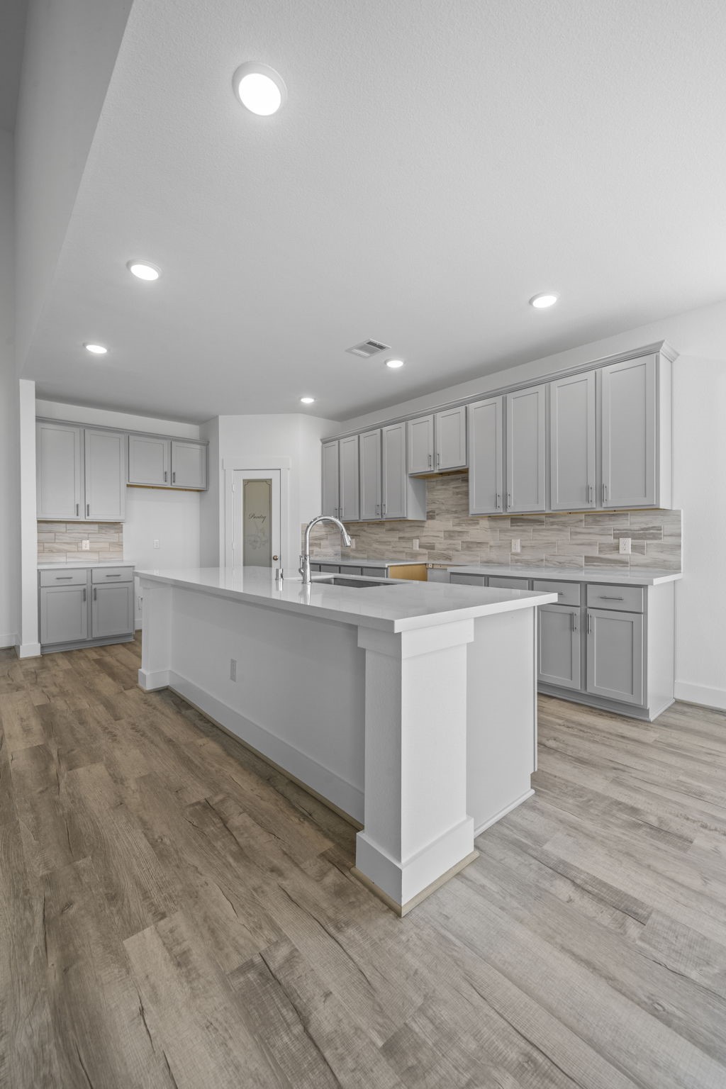 305 Gambels Quail Road Waller, TX 77484 - Photo 6 of 26 a kitchen with stainless steel appliances granite countertop a white stove top oven and white cabinets