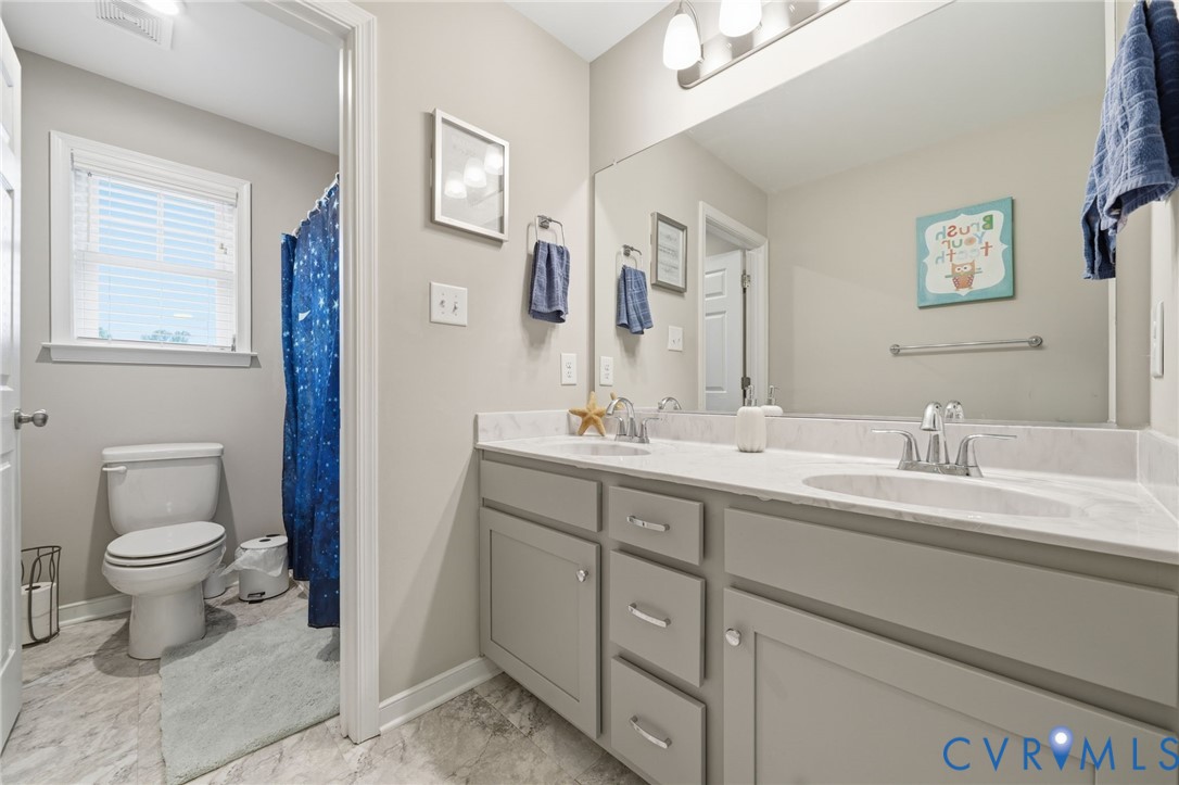 7598 Rural Point Road Mechanicsville, VA 23116 - Photo 28 of 41 a bathroom with a toilet sink and mirror