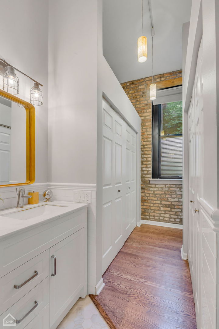 1001 West Altgeld Street, Unit 3 Chicago, IL 60614 - Photo 11 of 18 a bathroom with a sink a mirror and a shower