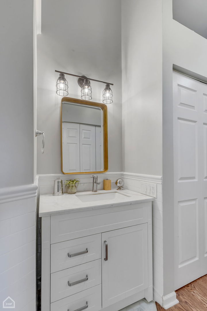 1001 West Altgeld Street, Unit 3 Chicago, IL 60614 - Photo 12 of 18 a bathroom with a sink vanity and a mirror