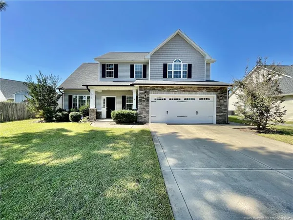 a front view of a house with a yard and garage