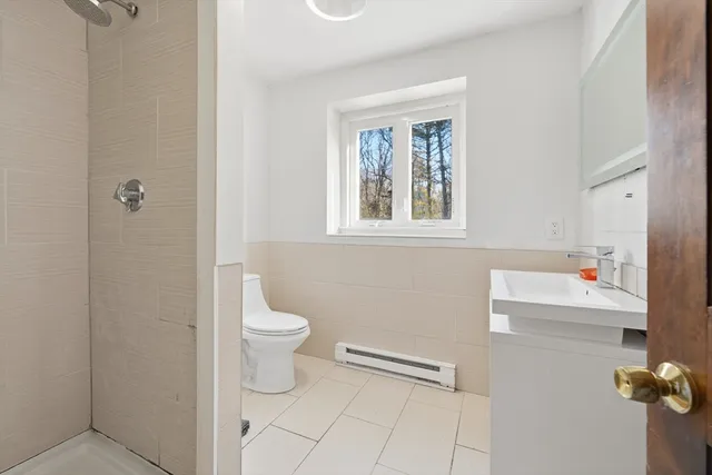 a white toilet sitting next to a bathroom sink