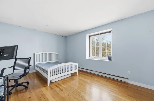 a bedroom with a bed window and a window