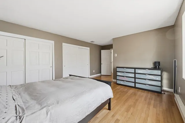 a bedroom with a bed and cabinets
