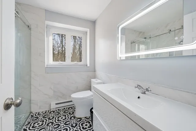 a bathroom with a sink a toilet and a bathtub