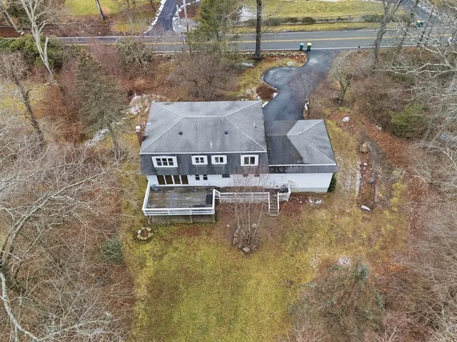 a view of a house with yard and sitting area