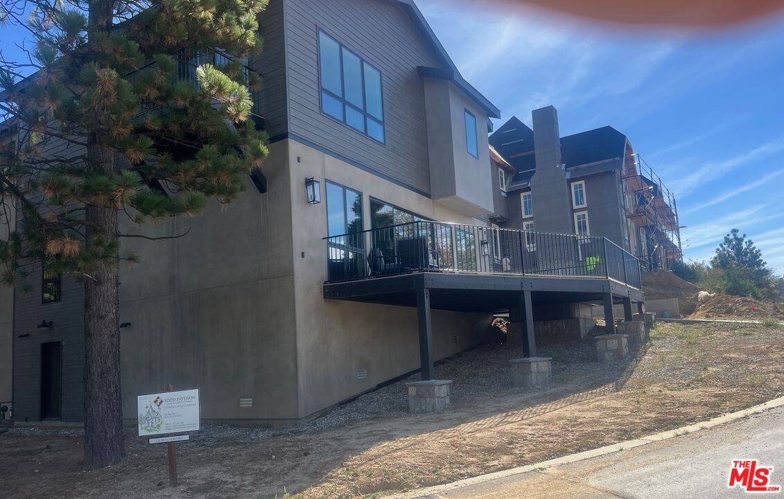 196 Mill Pond Road Lake Arrowhead, CA 92352 - Photo 18 of 36 a view of a building with a balcony