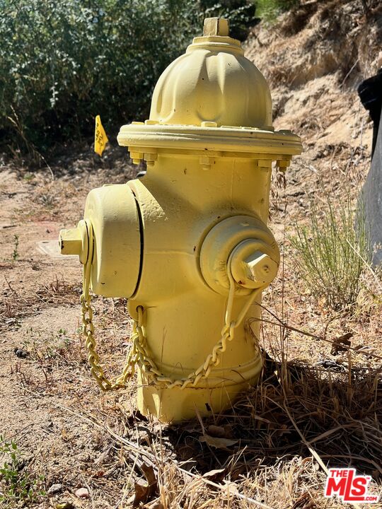 196 Mill Pond Road Lake Arrowhead, CA 92352 - Photo 31 of 36 a view of a swimming pool with a chairs and potted plants