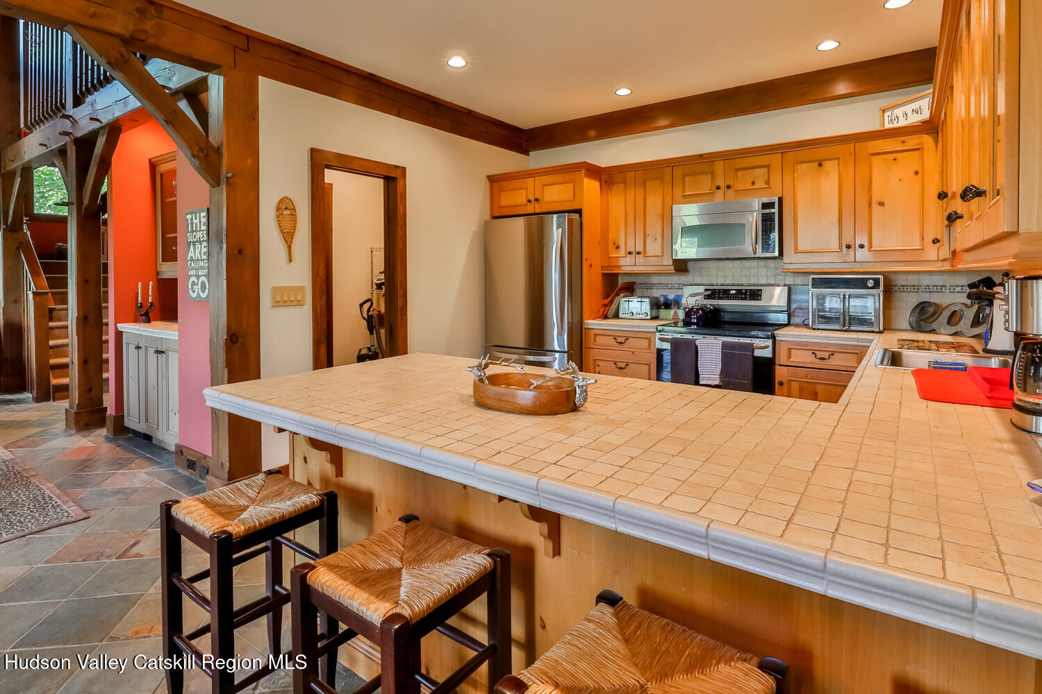 2 Watch Hill Lane, Unit 2 Windham, NY 12496 - Photo 19 of 41 a kitchen with stainless steel appliances kitchen island granite countertop a table chairs in it and a wooden floor