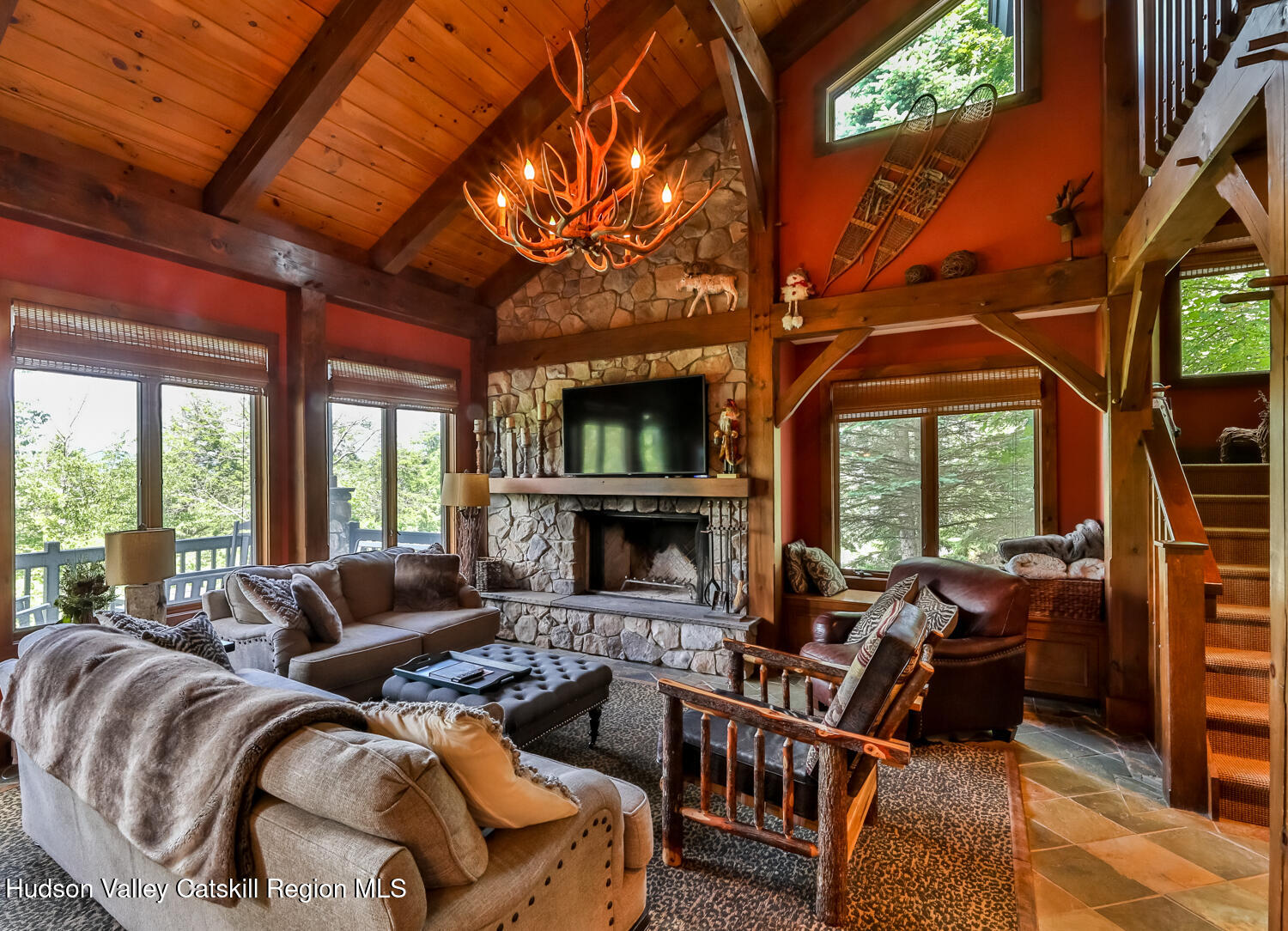 2 Watch Hill Lane, Unit 2 Windham, NY 12496 - Photo 8 of 41 a living room with furniture a fireplace and a floor to ceiling window
