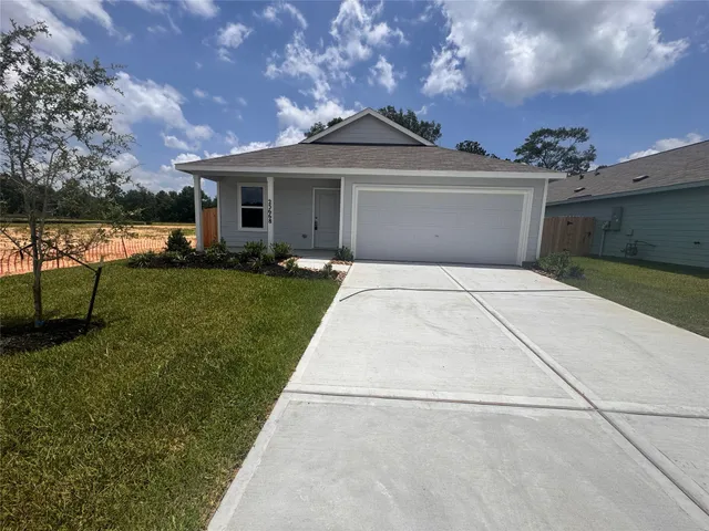 a front view of a house with a garden and patio