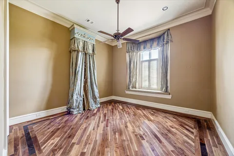 a view of room with window and wooden floor