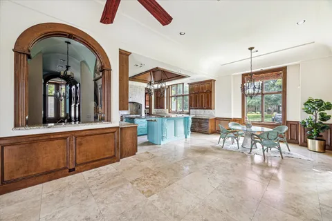 a room with lots of white furniture and windows