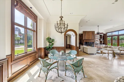 a dining room with furniture a chandelier and wooden floor