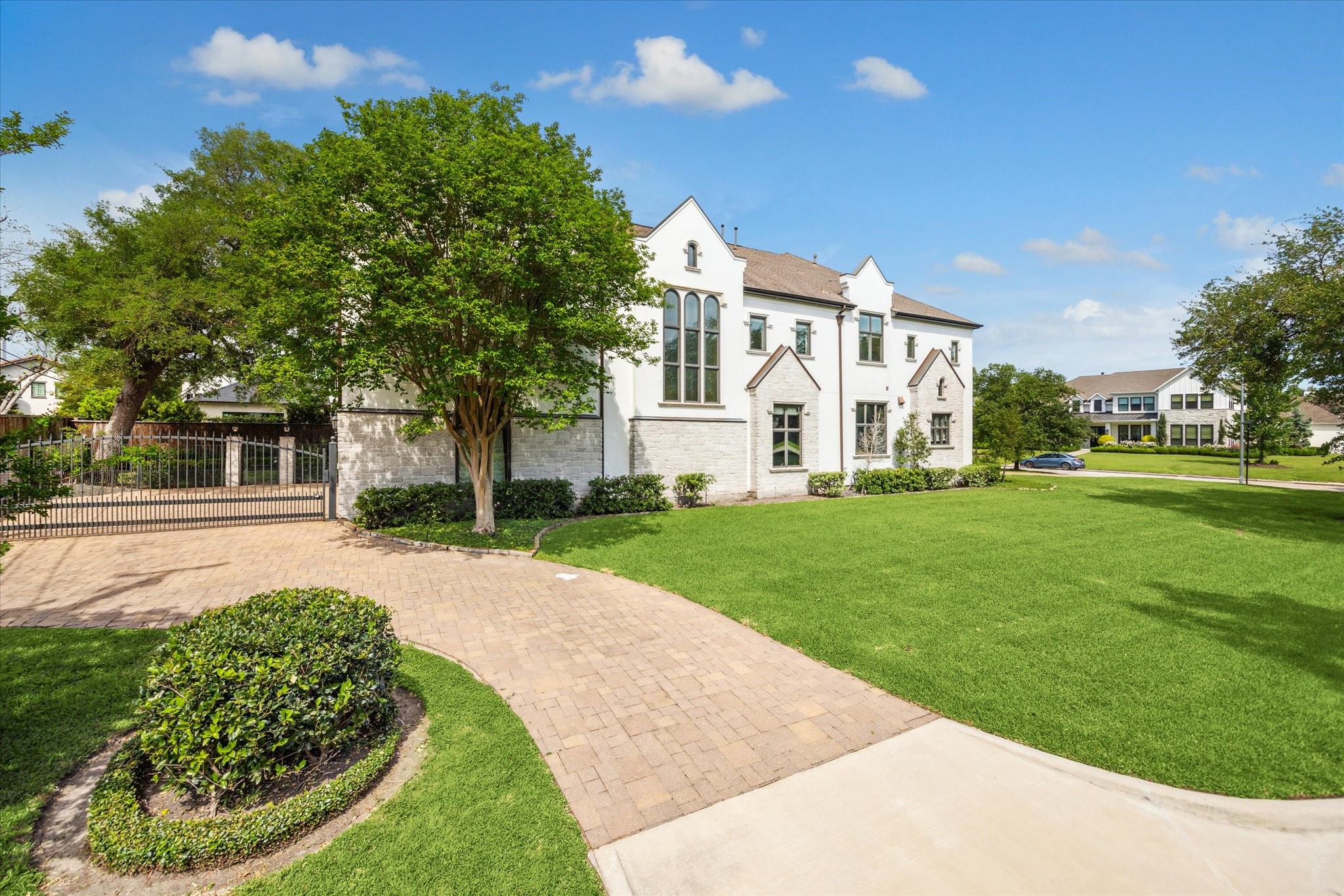 5303 Longmont Drive Houston, TX 77056 - Photo 3 of 50 a view of a white house with a big yard and potted plants