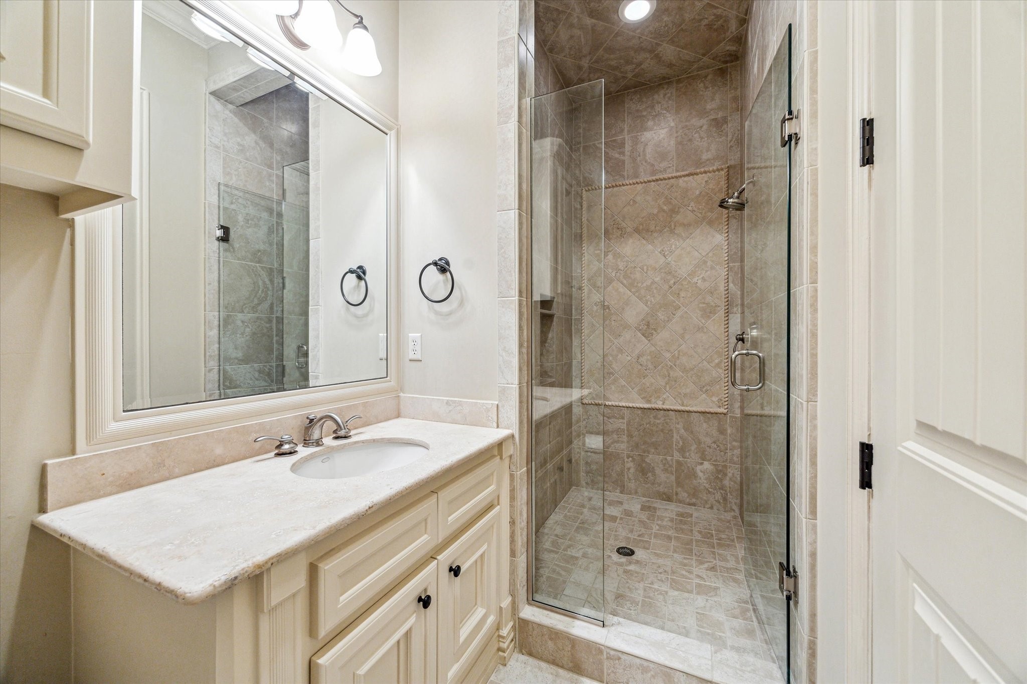5303 Longmont Drive Houston, TX 77056 - Photo 40 of 50 a bathroom with a shower sink and mirror