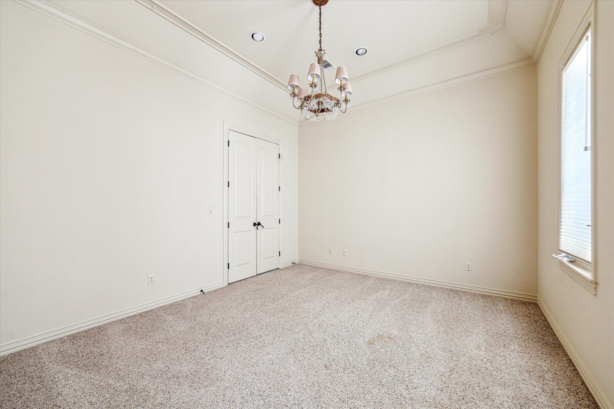 5303 Longmont Drive Houston, TX 77056 - Photo 41 of 50 an empty room with a chandelier fan and windows