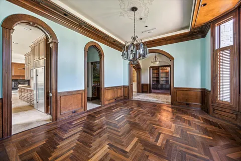 a view of a hallway with a chandelier and living room