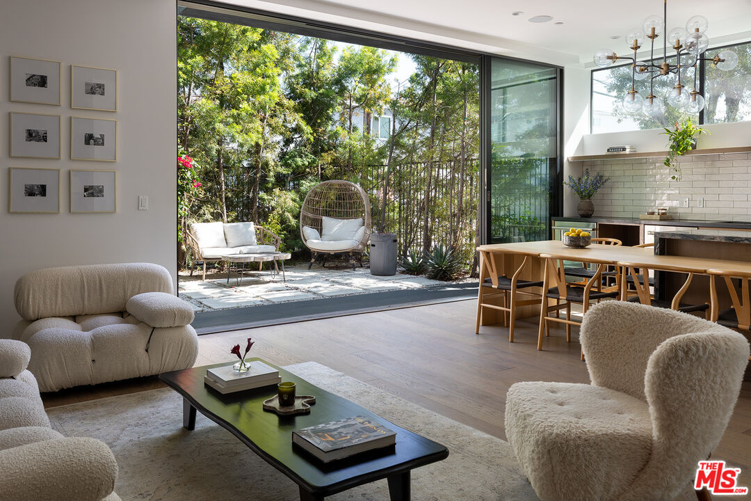 a living room with furniture and a floor to ceiling window