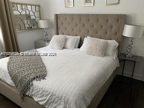 2221 Southwest 26th Lane Miami, FL 33133 - Photo 13 of 13 a bedroom with a bed and a night stand