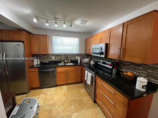 2221 Southwest 26th Lane Miami, FL 33133 - Photo 7 of 13 a kitchen with granite countertop a refrigerator stove and sink