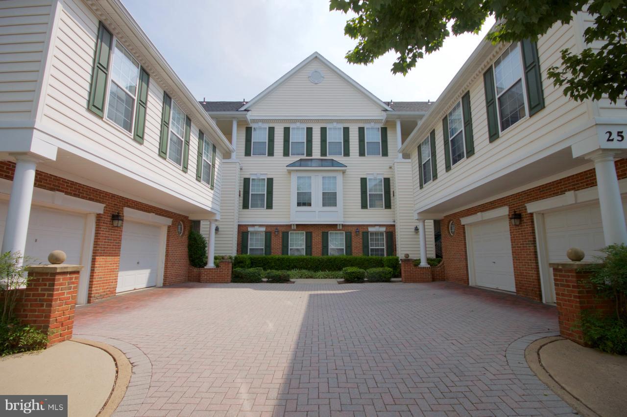 25252 Riffleford Square, Unit 101 Chantilly, VA 20152 - Photo 1 of 30 a view of a building next to a yard