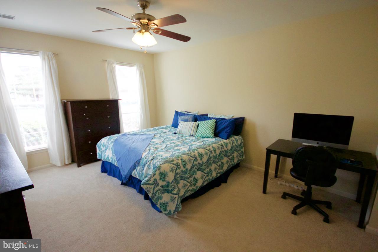 25252 Riffleford Square, Unit 101 Chantilly, VA 20152 - Photo 14 of 30 a bedroom with a bed and a window