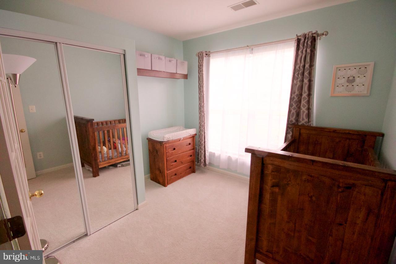 25252 Riffleford Square, Unit 101 Chantilly, VA 20152 - Photo 20 of 30 a living room with furniture and a window