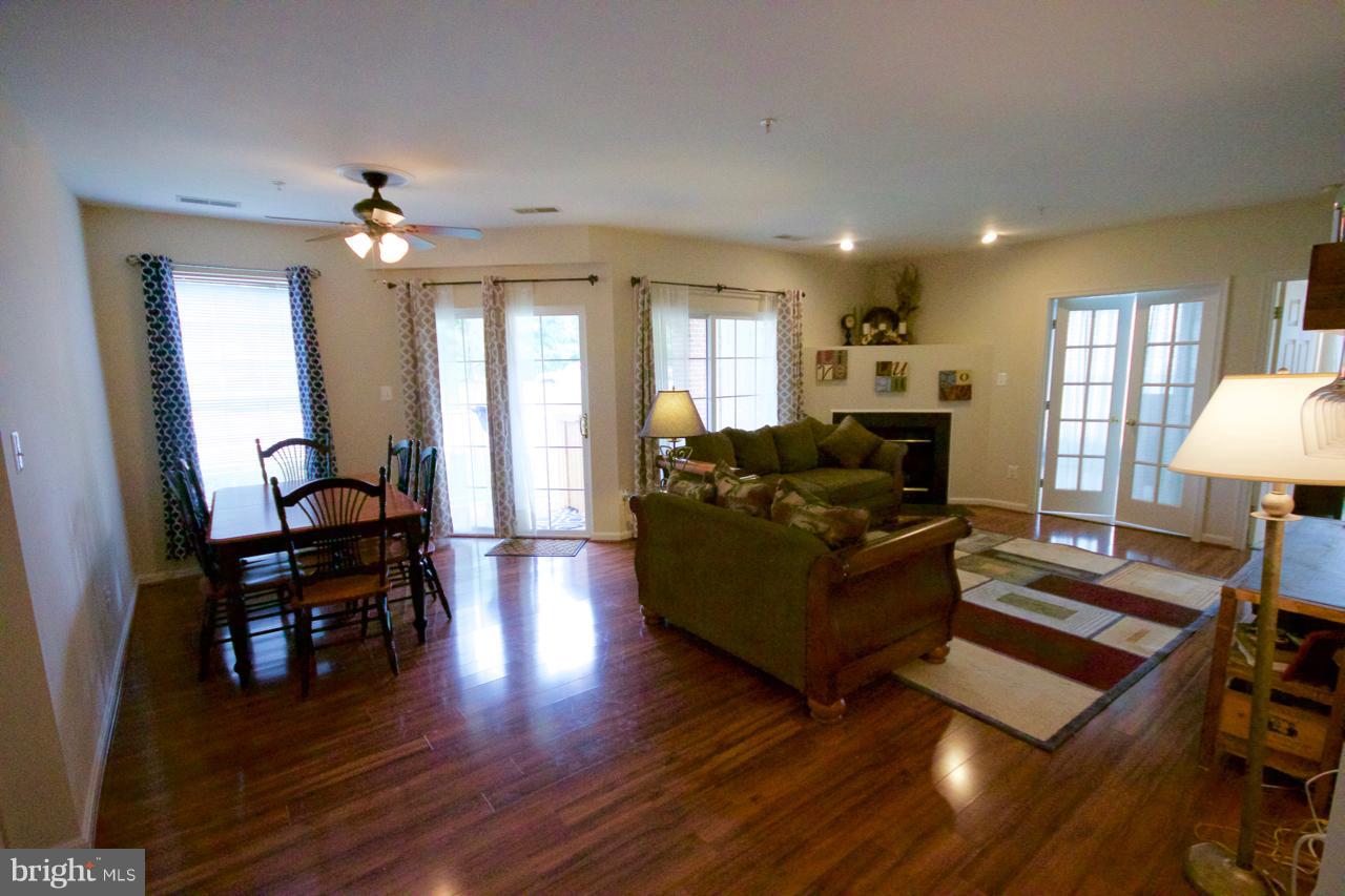 25252 Riffleford Square, Unit 101 Chantilly, VA 20152 - Photo 3 of 30 a living room with furniture and a wooden floor